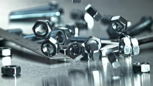 Reflective Chrome Wrench Among Assorted Hardware and Maintenance Tools Filmed on a Highspeed Camera