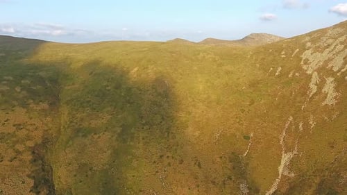 Aerial View of Mountain Ridge Flight Over Summit in Sunny Summer Day