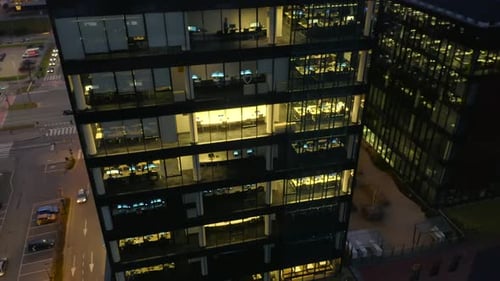 Drone Eye View of LateNight Corporate Work in Glass Skyscrapers