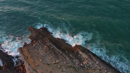 Aerial View of Rocky Cliff Coastline with Ocean Waves