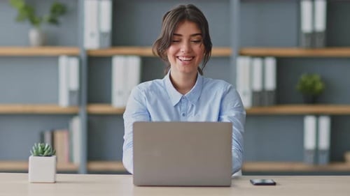 Young Woman Conducts Online Lesson at Home Using Laptop During Remote Education