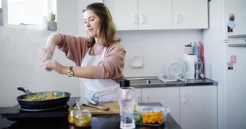 Woman Cooking Vegetables in Kitchen