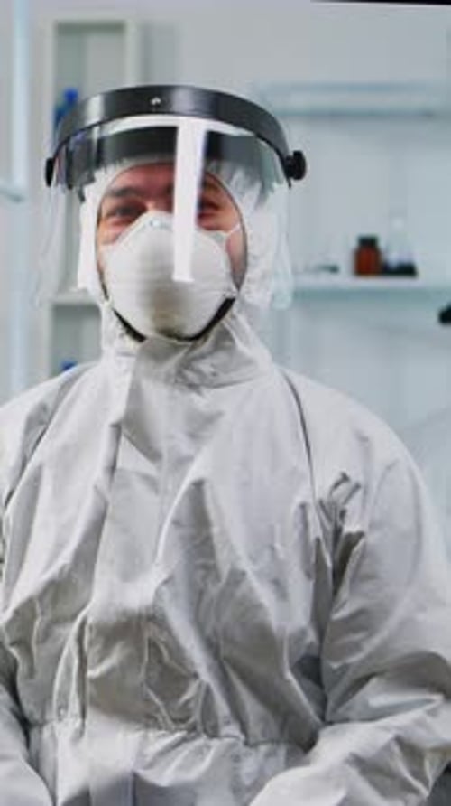 Medical Professional in Protective Suit Poses Indoors