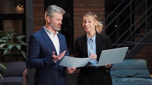 Business Colleagues Working Together on Laptop in Office