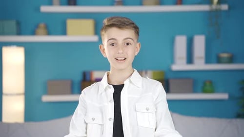 Boy is surprised and looking at camera in amazement.