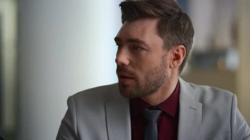 Confident businessman delivers corporate presentation at a modern office meeting