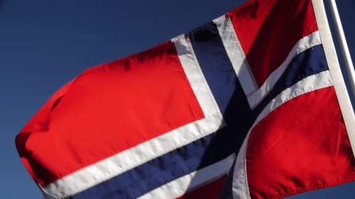 Norwegian Flag Waving Against a Blue Sky