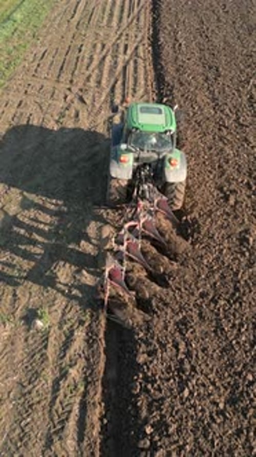 Tractor Plows Land In The Field Aerial
