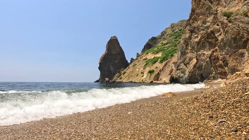 Small Sea Wave Blurred Soft Foamy Waves Washing Golden Sandy Beach and Volcanic Rocky Shores Nobody