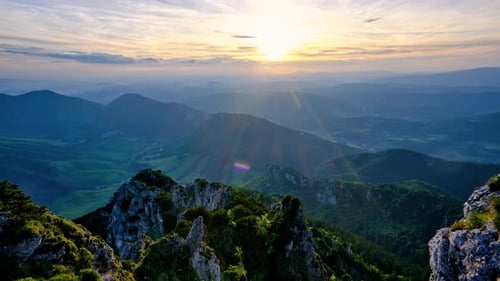The Sun Slowly Setting Behind the Clouds the Sun's Rays Illuminate the Idyllic Mountainous Landscape