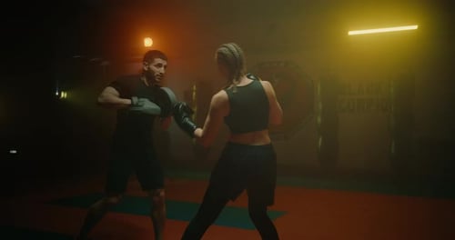 Sportswoman and Professional Male Coach Training in Gym Practicing Punches Prores