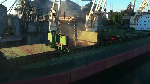 Aerial of Wheat Loading to Bulker Ship Cargo Hold at Sea Grain Elevator in Sea Port Wheat Shipment