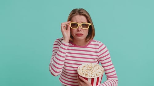 Woman Eating Popcorn with 3D Glasses Giving Thumbs Up