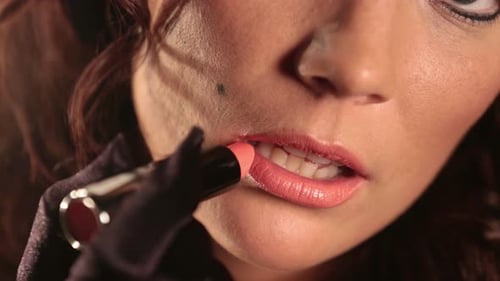 Woman Applying Coral Lipstick, Close Up Shot