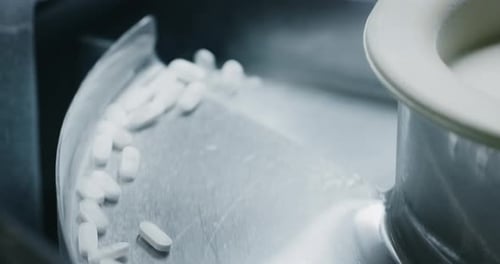 Close up of production of medical pills on automatic lines in a pharmaceutical factory. Concept of