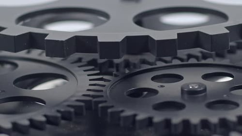 Rotating Grey Gears Interlock in Close Up