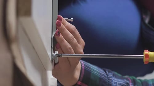 Woman Assembling Furniture with Screw Driver