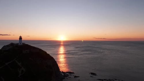 A Lonely Lighthouse on the Ocean at Dawn