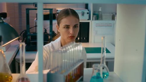 Woman Examining Test Tube in Laboratory