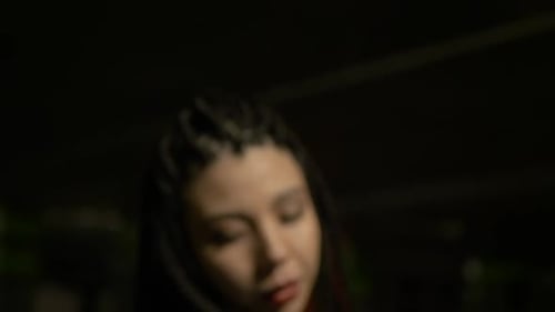 Stylish Woman with Braids Posing in Urban Setting