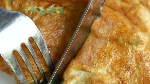 Eating Plain Egg Omelette on Table