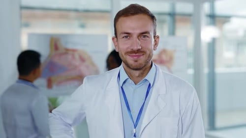 Smiling Doctor with Medical Staff in Background