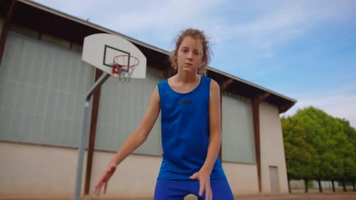 Young Athlete Dribbling Basketball on Urban Court