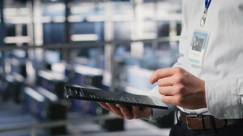 Close Up of Data Center Software Developer Doing Maintenance Tasks on Tablet