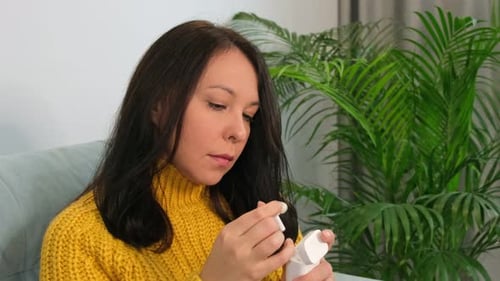 Woman Puts Wireless Earbuds in Ears