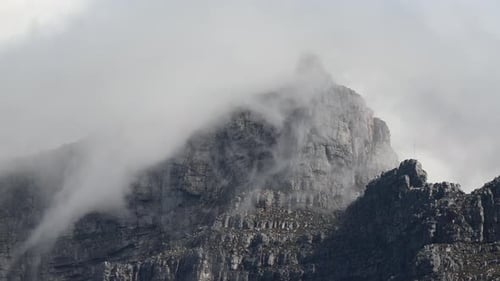 Massive mountain drowning in white clouds
