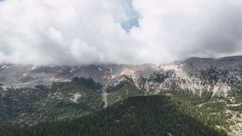 Vivid Dramatics Aerial View of Snowy Mountains and Clouds