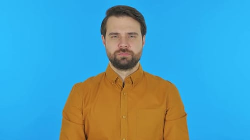 Man on Blue Background Giving OK Hand Sign