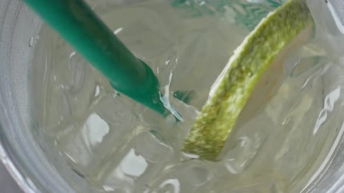 Refreshing Drink with Ice, Lime, and Straw