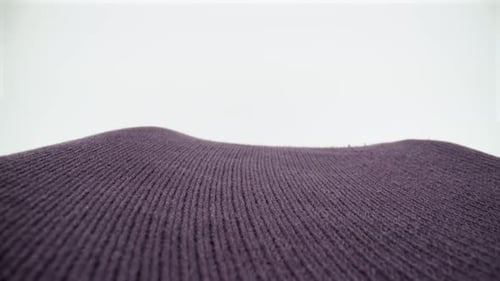 Purple sweater fabric close up on white background isolated 4K