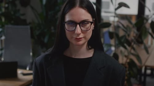 Young Woman in a Suit Stands in the Office Smiling The CEO Girl is Doing a Successful Business