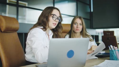 Colleagues Discuss Project Details While Collaborating in an Office Setting During the Afternoon