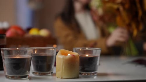 Glowing Candles and Autumn Leaves at Home