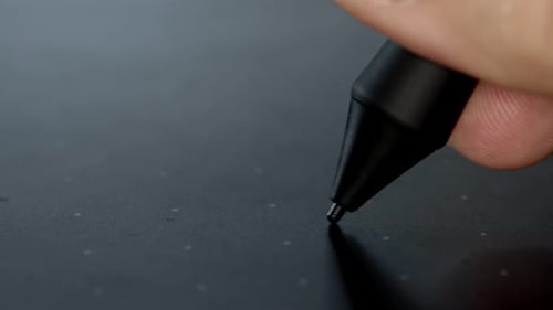 Graphic Designer working on tablet with stylus, digital drawing. Stylus pen draws on a graphic table