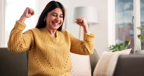Excited Woman Celebrates Success While Using Laptop