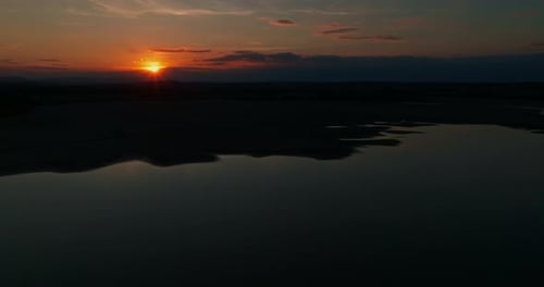 Beautiful View of the Sunset Over the Lake and the Mountains