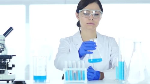 Woman Analyzing Scientific Experiment in Laboratory