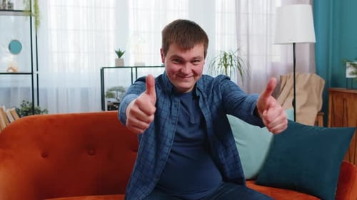 Excited Caucasian Man Looking Approvingly at Camera Showing Thumbs Up Like Sign Satisfied Feedback