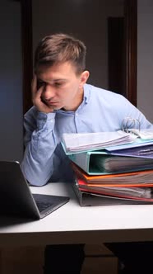Vertical Video Stressed Man Feeling Overwhelmed By Office Workload and Binders