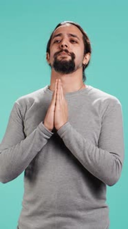 Devout Man Praying with Hands Clasped