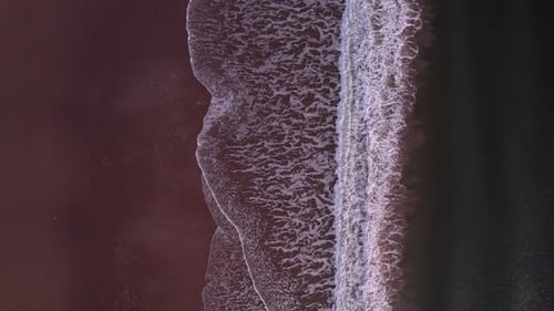 Espumosas olas oceánicas abstractas de arriba hacia abajo rompen la playa