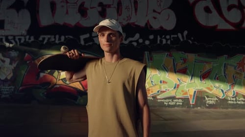 Smiling Man Having Break After Training at Skatepark. Handsome Male Person Looking