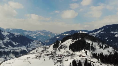 Winter In The Mountain Village. Snowy Mountains Panorama Aerial