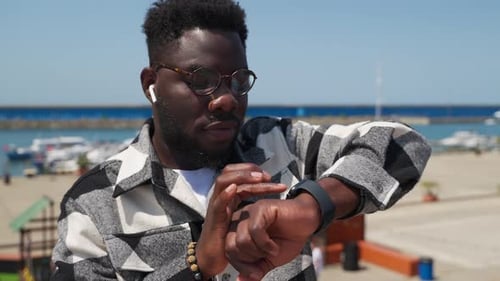 Young Adult Using Smart Watch Near Ocean