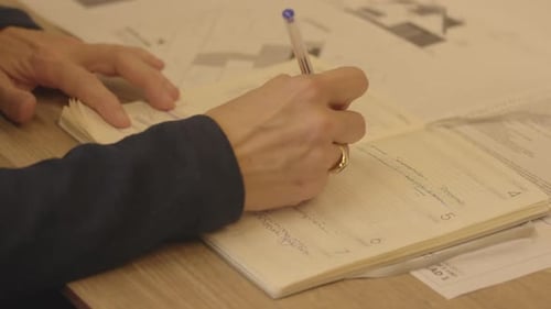 Female writing down in agenda