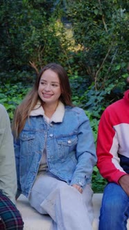 Friends Laughing and Chatting on a Park Bench